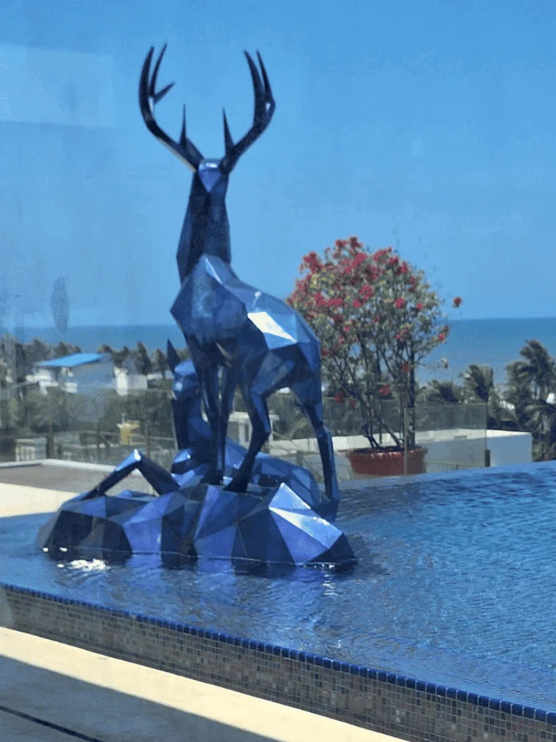 Mirror-polished stainless steel garden sculpture — Twin Spirits installation by FormForge